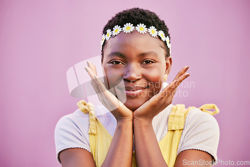 Image of Black woman, flower crown and smile in portrait by pink background for beauty, makeup and cosmetics. Happy african woman, hands and face for cosmetic glow, radiant and flowers for spring in Baltimore