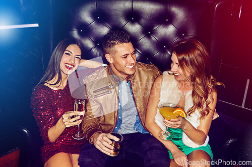 Image of Friends, club and party drinking alcohol at disco event, concert or happy hour for new years celebration together. Man and women with smile relaxing, clubbing and having fun at rave or nightclub