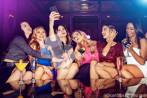 Image of Selfie, club and women with drinks at a party for new year, birthday or festive celebration. Fun, social and friends taking picture on a phone while drinking alcohol beverage in nightclub together.