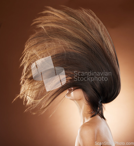 Image of Beauty, hair care and salon with flip of woman for shampoo, health and keratin treatment. Fashion, wind and cosmetics with profile of girl model for self love, growth and luxury in brown background