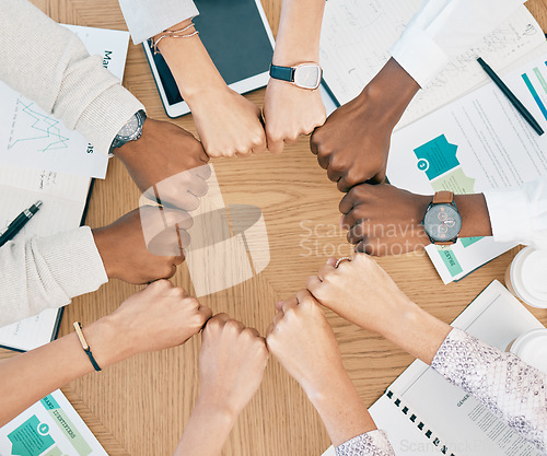 Image of Diversity, fist hands and teamwork with documents on table for marketing business meeting, creative collaboration and goals support motivation. Team, circle hand and planning strategy or logistics