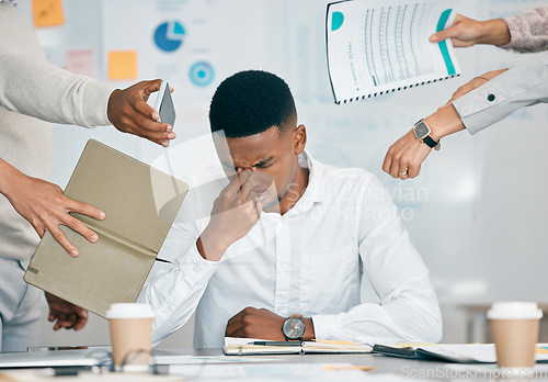 Image of Stress, burnout and tired black man with headache, frustrated or overwhelmed by coworkers at workplace. Overworked, mental health and anxiety of exhausted male worker multitasking at desk in office.