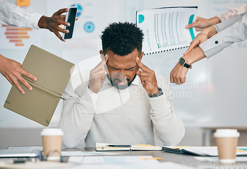 Image of Stress, burnout and tired black man with headache, frustrated or overwhelmed by coworkers at workplace. Overworked, mental health and anxiety of exhausted male worker multitasking at desk in office.