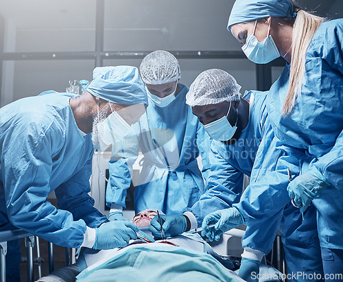 Image of Doctors, surgery and collaboration with a medicine team in scrubs operating on a man patient in a hospital. Doctor, nurse and teamwork with a medical group in a clinic to perform an operation