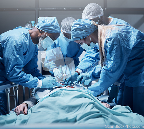 Image of Doctors, surgery and collaboration with a medicine team in scrubs operating on a man patient in a hospital. Doctor, nurse and teamwork with a medical group in a clinic to perform an operation