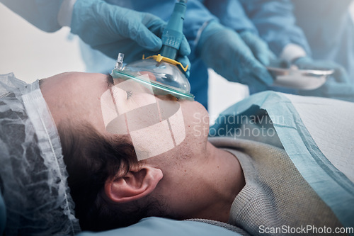 Image of Anesthesia, oxygen mask and medical with man in surgery for breathing, ventilation and operation. Healthcare, cardiology and paramedic with face of patient and doctors in operating room for emergency