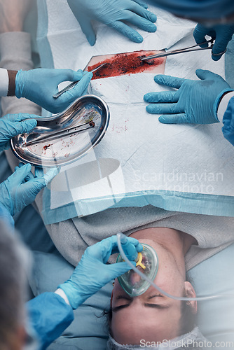 Image of Doctors, surgery and blood with a medicine team in scrubs operating on a man patient in a hospital. Doctor, nurse and teamwork with a medical group in a clinic to perform an operation