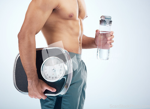 Image of Man, water bottle or scale for body fitness, workout or training progress in healthcare wellness, diet control or muscle growth. Sports athlete, personal trainer or coach with weight scale or drink