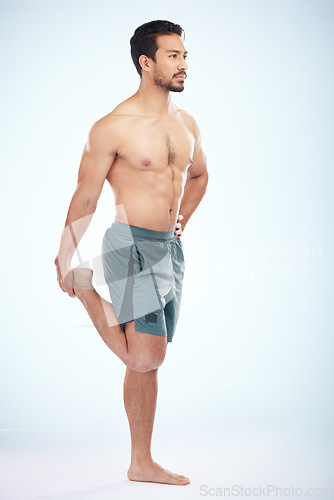 Image of Fitness, health and man stretching leg in studio isolated on a blue background mock up. Sports, body wellness and young male athlete stretch, warm up and preparing for workout, exercise and training.