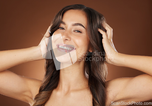 Image of Face portrait, hair care and beauty of woman in studio isolated on a brown background. Wellness, hairstyle and aesthetics of female model with healthy and long hair after salon treatment for growth.