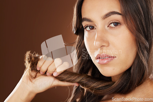 Image of Face portrait, hair care and beauty of woman in studio isolated on a brown background. Wellness, hairstyle and aesthetics of female model with healthy and long hair after salon treatment for growth.