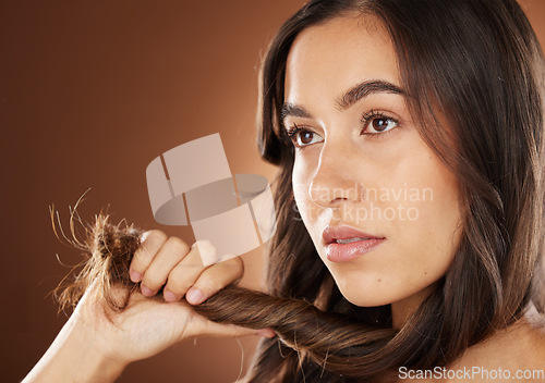 Image of Hair, beauty and skincare with a model woman in studio on a brown background for natural or keratin treatment. Face, haircare and salon with an attractive young female posing to promote a product