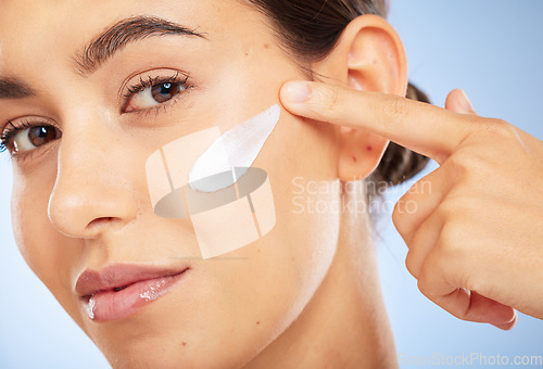 Image of Portrait, skincare and moisturizer with a model woman in studio on a gray background for antiaging beauty. Face, lotion and product with an attractive young female inside to apply facial treatment