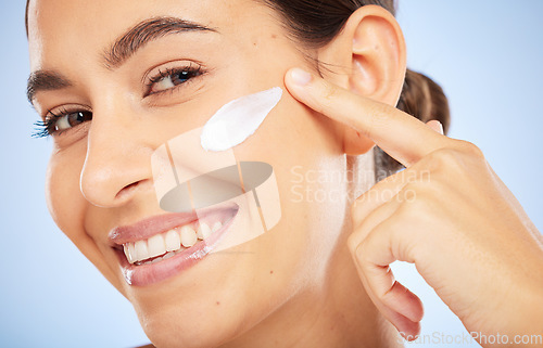 Image of Portrait, skincare and moisturizer with a model woman in studio on a gray background for antiaging beauty. Face, lotion and product with an attractive young female inside to apply facial treatment