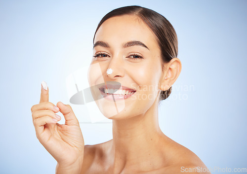 Image of Portrait, skincare and moisturizer with a model woman in studio on a gray background for antiaging beauty. Face, lotion and product with an attractive young female inside to apply facial treatment