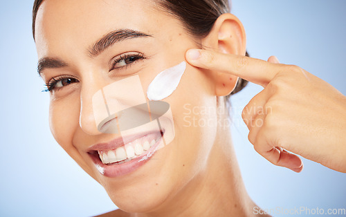 Image of Portrait, skincare and moisturizer with a model woman in studio on a gray background for antiaging beauty. Face, lotion and product with an attractive young female inside to apply facial treatment