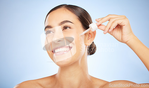 Image of Face, skincare and woman with serum for beauty in studio on a background. Thinking, cosmetics and female model with hyaluronic acid, essential oil and dropper product for healthy skin and anti aging.