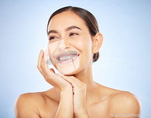 Image of Woman, face and happy thinking of beauty, skincare wellness or luxury salon spa dermatology on blue background. Facial care vision, happiness and model smile with cosmetics glowing skin in studio