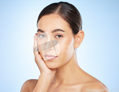 Image of Face portrait, beauty skincare and woman in studio isolated on a blue background. Makeup, natural cosmetics and young female model with glowing, healthy and flawless skin after spa facial treatment.