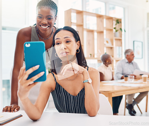 Image of Selfie, friends and a business black woman posing for a photograph in the office with her colleague. Phone, diversity and social media with a female employee and coworker taking a picture at work