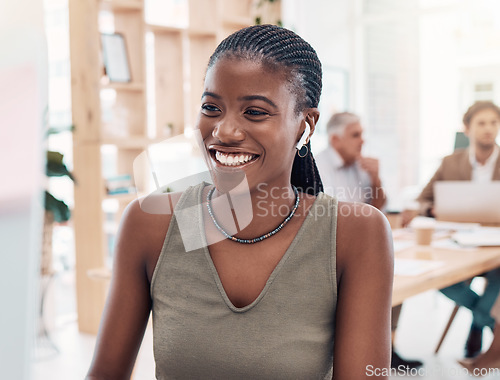 Image of Music, podcast and woman at computer with earphones in office with streaming service while working. Work, smile and happy black woman listening to streaming radio station app online in modern office.