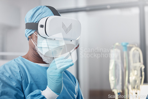 Image of Virtual reality, medical and doctor with a surgery simulation in operation room in the hospital. Vr, healthcare and male surgeon practicing and analyzing the human anatomy with futuristic device.