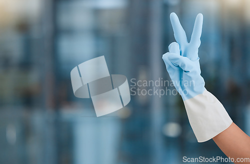 Image of Hand, peace and mockup with a woman cleaner in an office for hygiene or company housekeeping. Cleaning, job and service with a female housekeeper gesturing a hand sign while in a workplace to clean