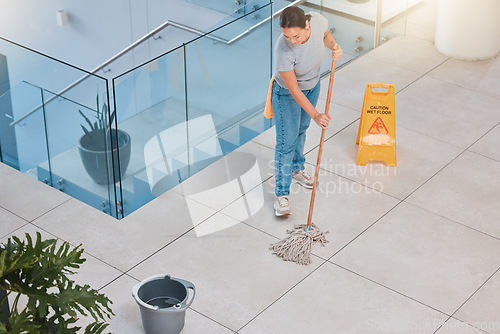 Image of Cleaning service, office building or woman mopping floor with warning sign for job safety compliance. Bucket, bacteria or girl cleaner working on wet floor for dirty, messy or dusty tiles on ground