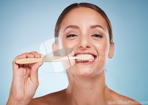 Image of Brushing teeth, dental and woman with toothbrush for teeth whitening and beauty, oral health and fresh breath with studio background. Mouth wellness, Invisalign portrait and clean with bamboo brush.