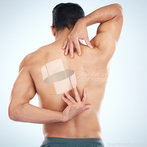 Image of Man, body or stretching back muscles on blue background in studio pain relief, healthcare wellness or burnout tension release. Sports athlete, fitness model or coach flexing in workout success check
