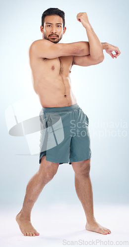 Image of Man, body or stretching arms on studio background in workout start, exercise pain relief or training healthcare wellness. Portrait, sports athlete or fitness model warm up of strong muscles