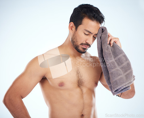 Image of Man with towel after fitness, tired and sweat from workout with health and body care against studio background. Sports training, motivation and exhausted athlete wipe head with wellness and cardio.