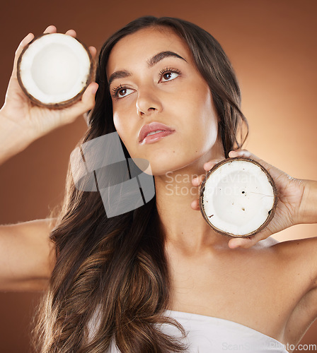 Image of Coconut skincare beauty, woman and studio for health, wellness and natural radiant glow by backdrop. Model, face and fruit for nutrition, cosmetics or coconut oil for skin moisturizer by background