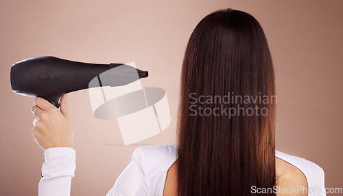 Image of Hair, hair care and beauty with woman and hairdryer, cosmetic appliance or tools for keratin treatment, Brazilian and back view. Glow, shine and wellness with strong long hair with studio background.