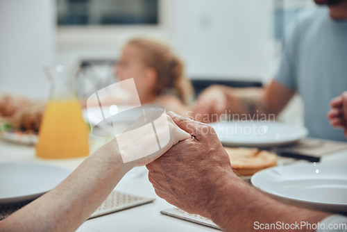 Image of Family, holding hands and praying for lunch in home dining room table. Gratitude, faith and prayer, worship or thanksgiving of parents, grandparents and children before eating food, brunch or buffet.