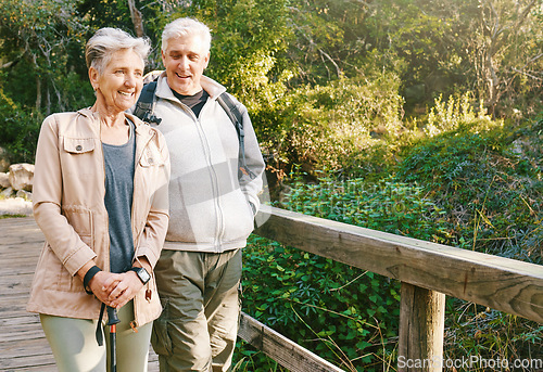 Image of Senior hiking couple, bridge and nature on outdoor adventure, summer sunshine or bonding together. Elderly man, old woman and happiness with smile, love or walking in woods, forest or park for health