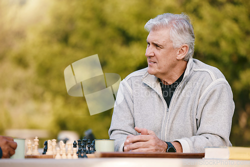 Image of Senior man, park and thinking for chess, game and competition at table by trees, sunshine and focus. Elderly chess player, outdoor and strategy for contest in nature, relax and play in Los Angeles