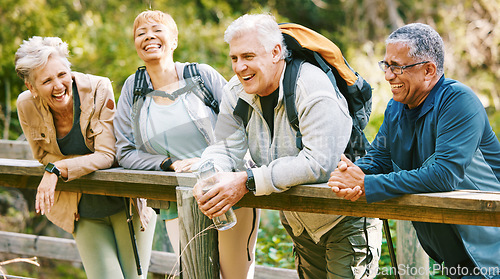 Image of Elderly, people hiking and happy in park with fitness outdoor, relax on bridge while trekking in nature together. Health, wellness and hiker group, sport and active lifestyle motivation with cardio.