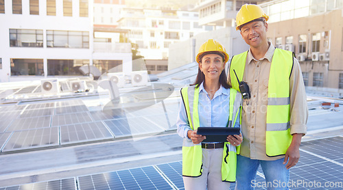 Image of Solar energy, building and engineer team portrait with tablet, smile or rooftop for sustainability. Man, woman and solar panel in city for renewable energy on roof with mobile tech, teamwork and goal