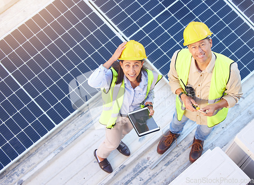 Image of Solar panels, digital tablet and top view of team doing maintenance, repairs or inspection. Solar energy, collaboration and portrait of industry workers on rooftop of building for photovoltaic cells.
