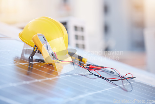 Image of Tools, solar panels or helmet on roof for solar energy installation in a city development project. Voltmeter, Construction, renewable energy or electric engineering equipment for building maintenance