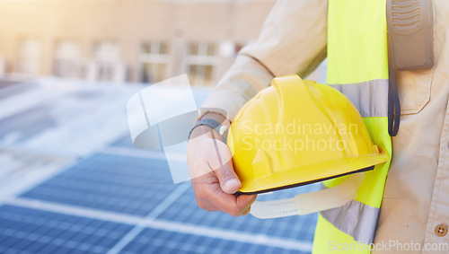 Image of Engineering, solar energy or hand with helmet for safety while working on photovoltaic development project. Industry hat, solar panels or construction worker working on building rooftop maintenance