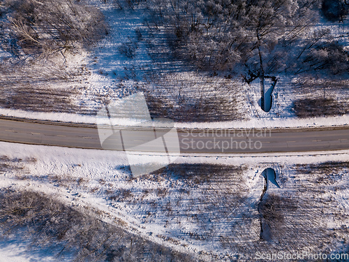 Image of Aerial view of winter road, in sunny day