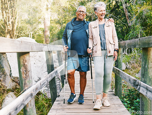 Image of Relax, senior or couple of friends hiking, walking or trekking for freedom, exercise or fitness in nature forest. Interracial, travel or happy woman enjoys bonding time with healthy elderly partner