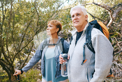 Image of Relax, senior or couple of friends hiking, walking or trekking for freedom, exercise or fitness in nature forest. Interracial, travel or happy woman enjoys bonding time with healthy elderly partner