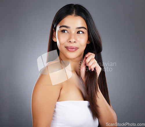 Image of Beauty, hair care or girl model in studio grooming with healthy natural growth products for self love or self care. Studio background, wellness or beautiful woman with pride, confidence or freedom