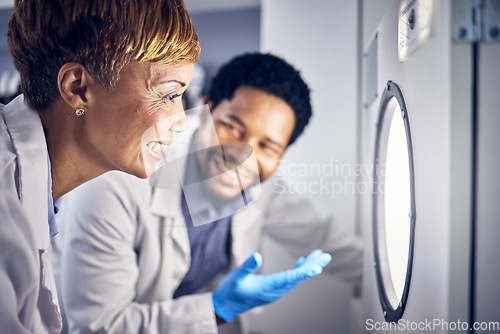 Image of Science, man and woman in laboratory, research and test sample for cure, vaccine or conversation. Researchers, scientist or staff talking, data analysist and check experiment for innovation or expert