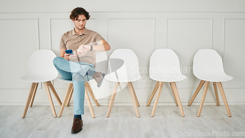 Image of Recruitment waiting room, phone and man with watch to check job interview time, schedule or appointment. Job search, hiring and person with late interview delay, smartwatch clock app and mobile tech