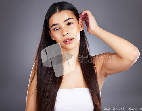 Image of Portrait, woman and hair care for shine, natural beauty and grooming on studio background. Female, girl and hair style for confidence, cosmetics treatment and keratin for wellness, glow and luxury.