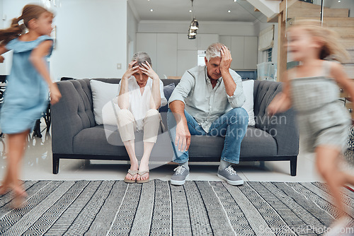 Image of Burnout headache, children running and parents on living room sofa with migraine from hyper active kids. Mental health problem, family stress and senior grandparents tired from babysitting adhd girl